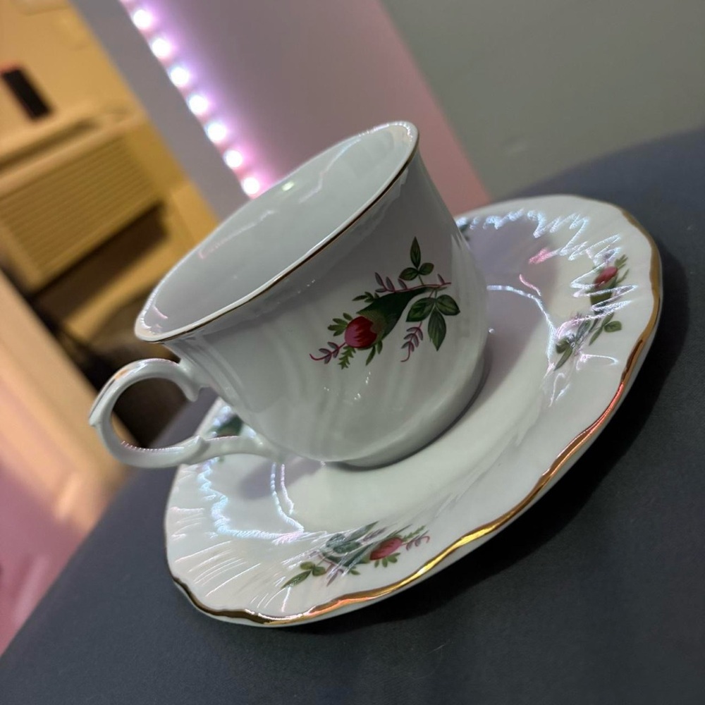 White with gold colored rim fine china rose design vintage teacup and saucer